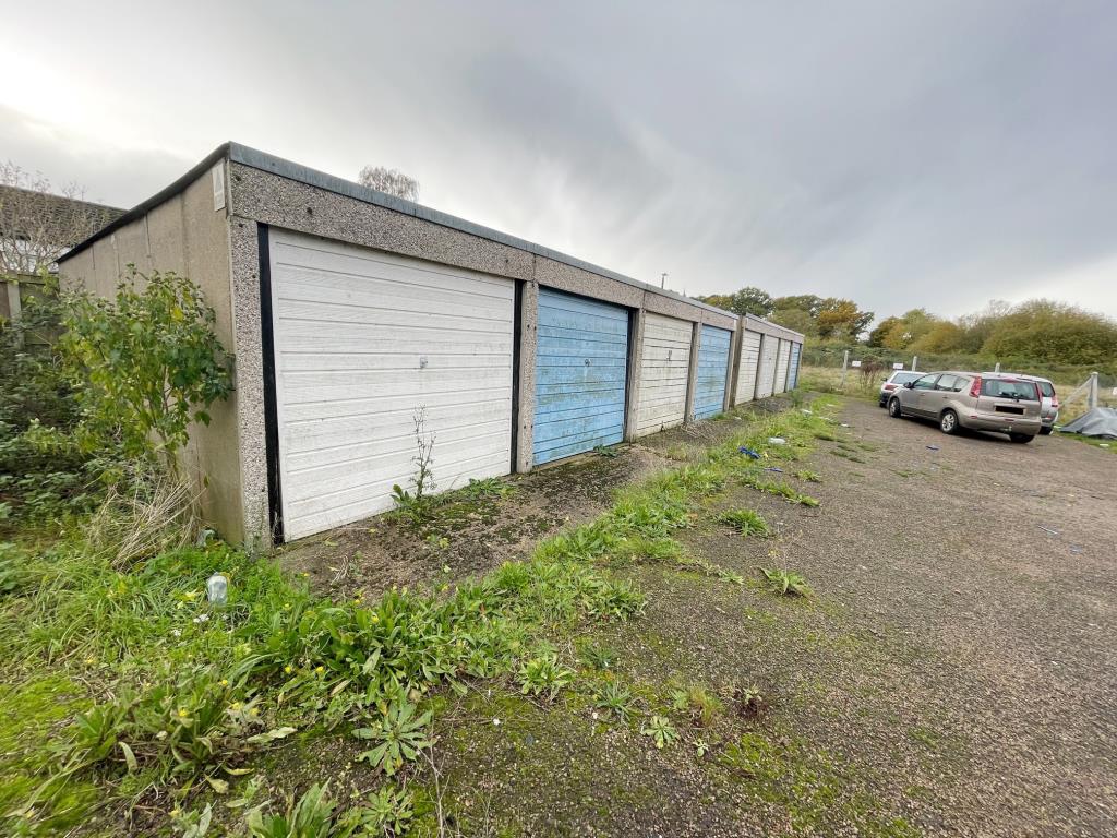 Lot: 61 - FREEHOLD LAND & SIX LOCK-UP GARAGES - Garages looking left to right 2 in the nearest block not included